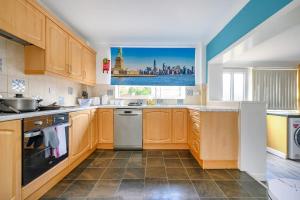 a kitchen with wooden cabinets and a view of the city at *328OL* For your relaxed & Cosy stay + Parking in Leeds