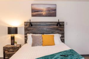 a bedroom with a bed with a wooden headboard at Upscale Ybor House with Outdoor Living Space in Tampa