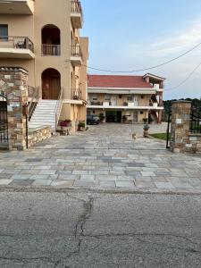 a dog is standing in front of a building at Flo's Apartment in Missolonghi