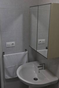a white bathroom with a sink and a mirror at Aireluz, miradoiro á ría in Raxó +20 photos