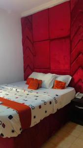 a bedroom with a bed with a red headboard at Blue Moon Hotel Victoria Island in Lagos