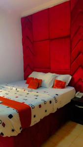 a bedroom with a red headboard and a bed at Blue Moon Hotel Victoria Island in Lagos