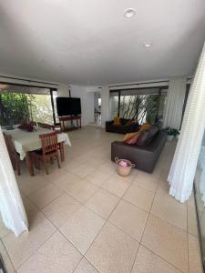 a living room with a couch and a table at Casa Villa Lele in Salvador