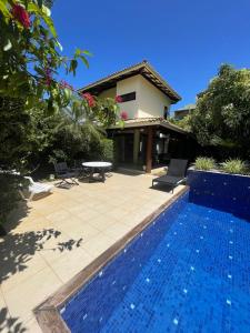 a swimming pool in front of a house at Villa Lele in Salvador