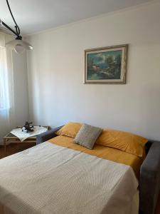 a bedroom with a bed and a painting on the wall at Casa Vacanze Diva in Rosignano Solvay