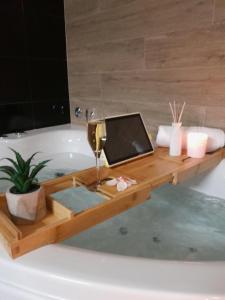 a bath tub with a laptop on top of it at Luxury Apartment Mare in Brodarica