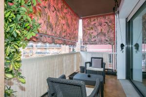 a balcony with two chairs and a table and a window at Apartment 15' to Sagrada Familia in Barcelona