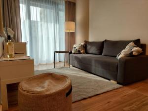 a living room with a couch and a table at Hanza Tower STETT-INN Business & Holiday in Szczecin
