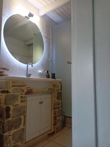 a bathroom with a sink and a mirror at A&V's Home in Agioi Apostoli