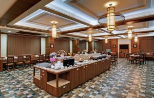 a banquet hall with tables and chairs in a room at The Fern Residency Somnath in Somnath