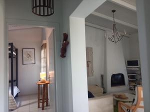 a living room with a couch and a chandelier at A&V's Home in Áyioi Apóstoloi