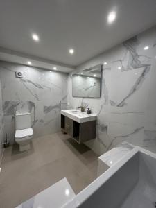 a bathroom with a toilet and a sink and a mirror at A Eze , Bas de villa piscine près de Monaco in Éze