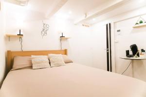 a bedroom with a white bed with two pillows at Studio palais des festivals Croisette in Cannes +5 photos