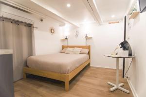 a small bedroom with a bed and a table at Studio palais des festivals Croisette in Cannes