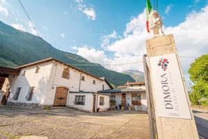 a sign for a hotel in front of a building at Dimora Perla di Villa - Historical Wine Retreat near Bernina Express in Villa di Tirano