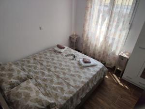 a bedroom with a bed with two towels on it at Dafnonas House - Bright & Modern in Leonidion