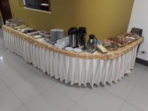 a long table with food on top of it at Hotel Horizonte in Machu Picchu
