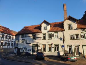 a large white building with cars parked in front of it at "Bedroo 2" Ferienwohnung am historischen Hafen in Wanfried