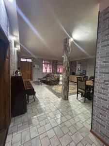 a large living room with a pillar in the middle at HamEl Guest House in Odzun