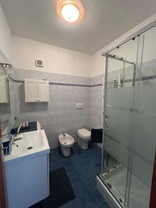 een badkamer met een wastafel, een toilet en een douche bij La casa nel verde in Lavagna