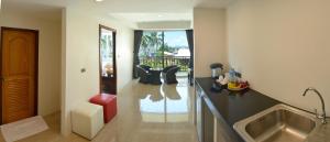 a kitchen with a sink and a counter top at David Residence in Nai Yang Beach