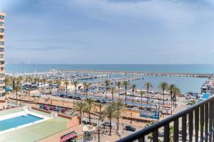 a view from a balcony of a beach and a harbor at Paseo Marítimo Rey de España in Fuengirola