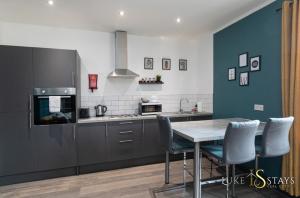a kitchen with a table and chairs in a kitchen at Luke Stays - Granville Street in Gateshead