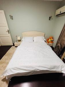 a bedroom with a large white bed in it at Unique apartment in Almaza in Cairo