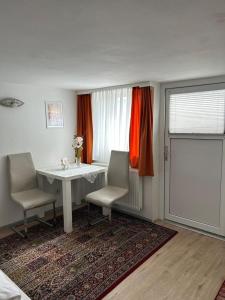 a room with a table and two chairs and a window at Apartment Harmony in Graz