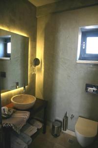 a bathroom with a sink and a toilet at Anemos Hotel in Gokceada Town