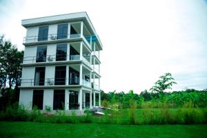 a white building with balconies on the side of it at Shose Farm House in Shiri