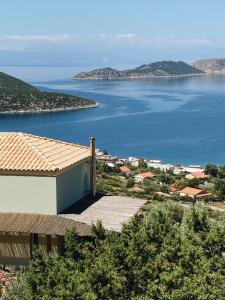 a house with a view of a body of water at Melolia Estate in Thiva