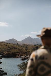 a man looking out at a river and mountains at Mossie's in Adrigole