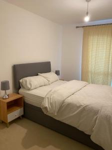1 dormitorio con cama, lámpara y ventana en Home Stay en Belvedere