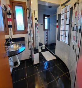 a bathroom with a sink and a toilet at Pousada Krolow in Pelotas