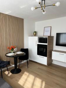 a living room with a table and a television at Voyage in Kehl am Rhein