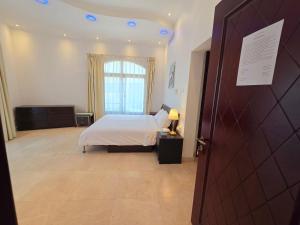 a bedroom with a bed and a large window at Stay Room Jumeriah Dubai in Dubai