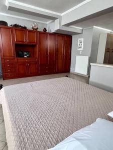 Άνετο διαμέρισμα : غرفة نوم كبيرة مع سرير ودواليب خشبية