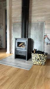 a fireplace in a room with a wooden floor at Domki wypoczynkowe LAS in Śliwice