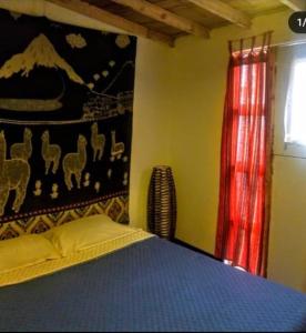 a bedroom with a bed and a painting on the wall at Vieja Aduana in Zipaquirá