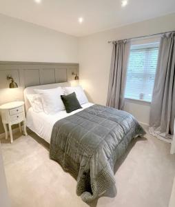 a bedroom with a large bed and a window at Yarm Luxury Apartments - Bank House - private gated carpark in Stockton-on-Tees