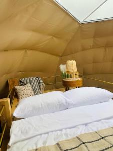 a bedroom with a bed in a tent at IdyllaGlamp- Glamping Boho in Dzbądzek