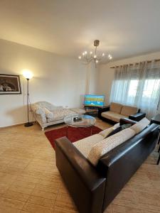 uma sala de estar com um sofá e uma mesa em Lovely apartment Tirana em Tirana