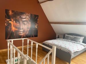 a room with a bed and a large painting on the wall at B&B DeSo in Zonnebeke