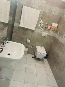 a bathroom with a sink and a toilet at FA_HOLIDAYS in Vlorë