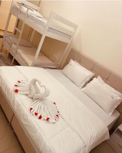 a bed with two bunk beds and a ladder at FA_HOLIDAYS in Vlorë