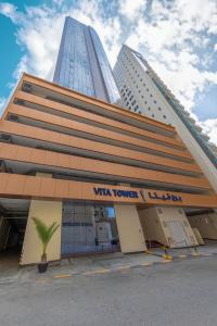 a building with a sign on the front of it at Vita Tower in Manama