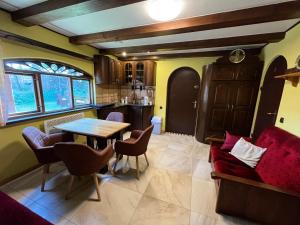 a living room with a table and a couch at Łęgowska Dolina in Olecko
