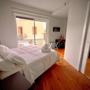 a bedroom with a bed and a large window at Taormina Boutique Rooms in Taormina