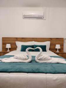 ein Bett mit zwei Schwänen, die wie Schlangen aussehen. in der Unterkunft A Casa da Formosinha in Madalena